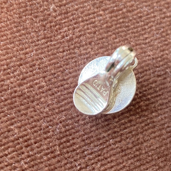 Monet signed small dome clip earrings. Bright shiny chrome. Also marked Patd - Picture 3 of 4